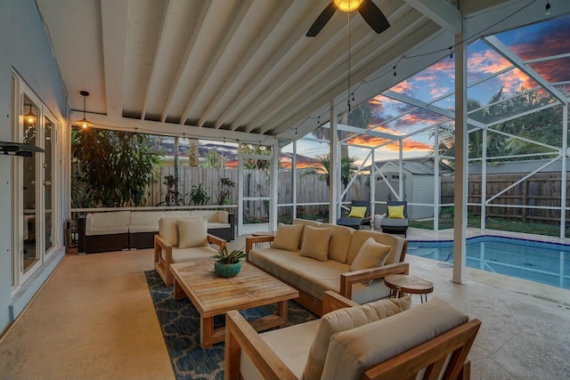 sunroom featuring beam ceiling, ceiling fan, and a swimming pool