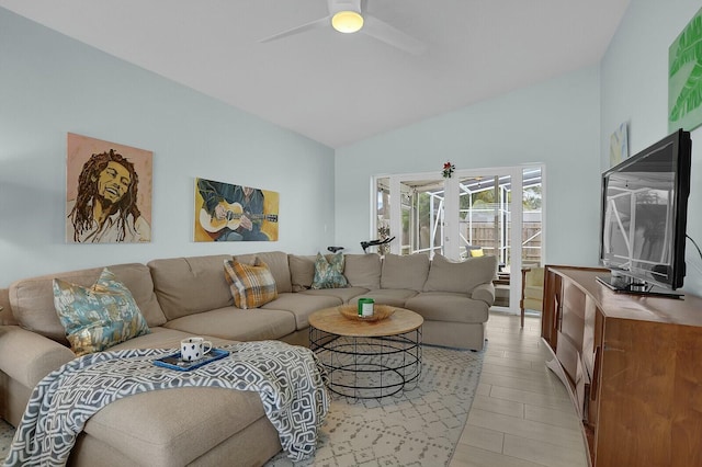 living room featuring ceiling fan and lofted ceiling