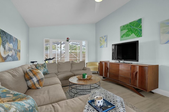 living room featuring light hardwood / wood-style floors and lofted ceiling