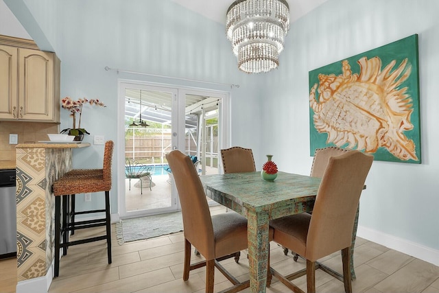 dining area with a towering ceiling and a chandelier