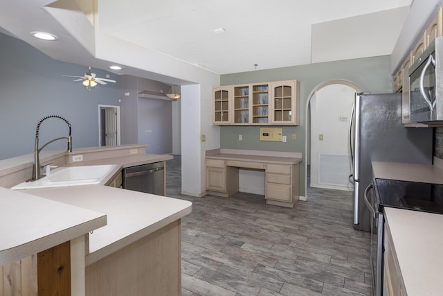 kitchen featuring ceiling fan, sink, stainless steel appliances, light brown cabinetry, and light wood-type flooring