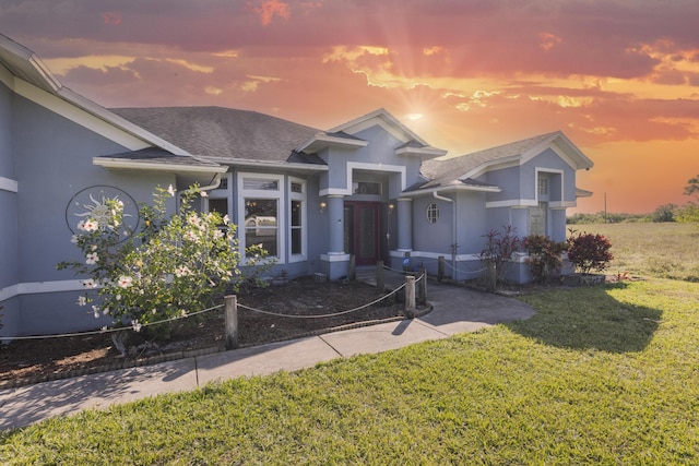 view of front of property with a lawn