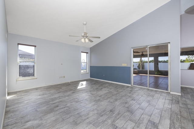 spare room featuring ceiling fan, hardwood / wood-style floors, and high vaulted ceiling