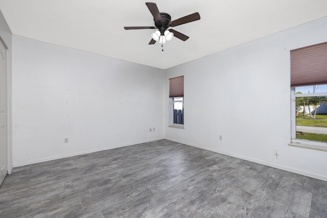 unfurnished room featuring dark hardwood / wood-style flooring and ceiling fan