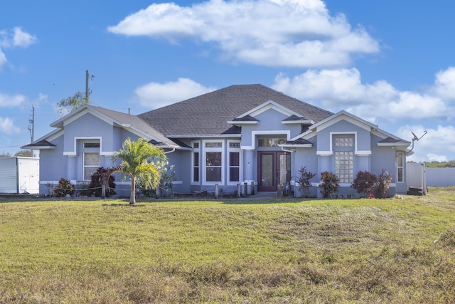 view of front facade featuring french doors and a front lawn