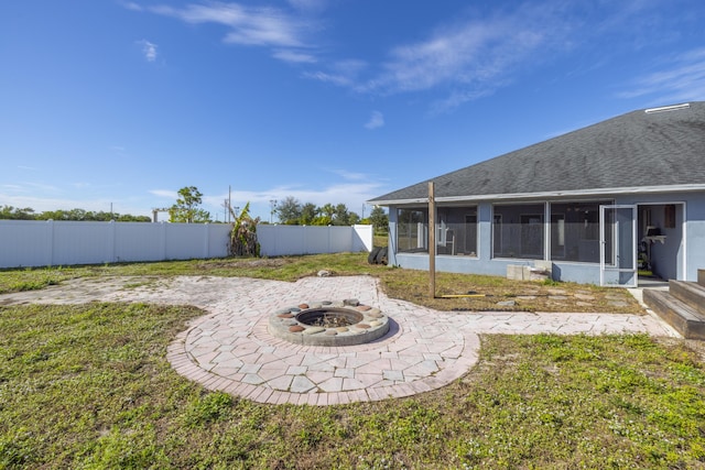 view of yard featuring an outdoor fire pit, a patio area, and a sunroom