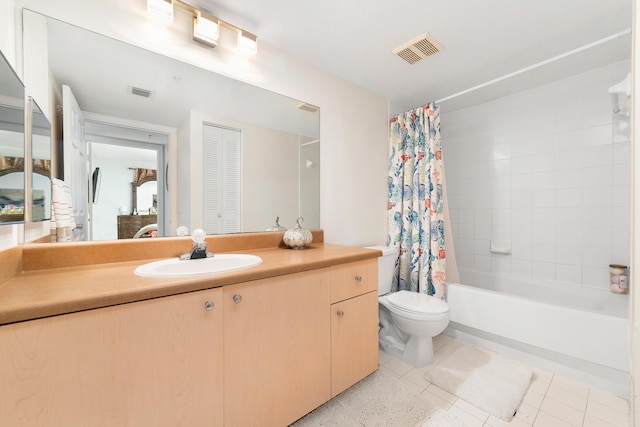 full bathroom featuring tile patterned floors, vanity, toilet, and shower / tub combo