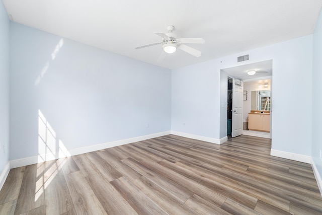 unfurnished room with hardwood / wood-style floors and ceiling fan