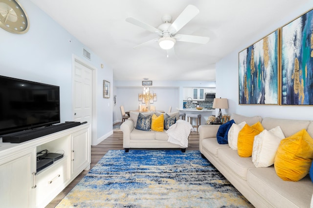 living room featuring dark hardwood / wood-style floors and ceiling fan