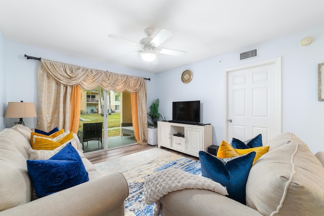 living room with wood-type flooring and ceiling fan