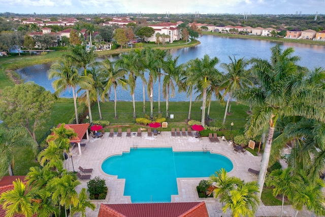 view of swimming pool with a patio area and a water view