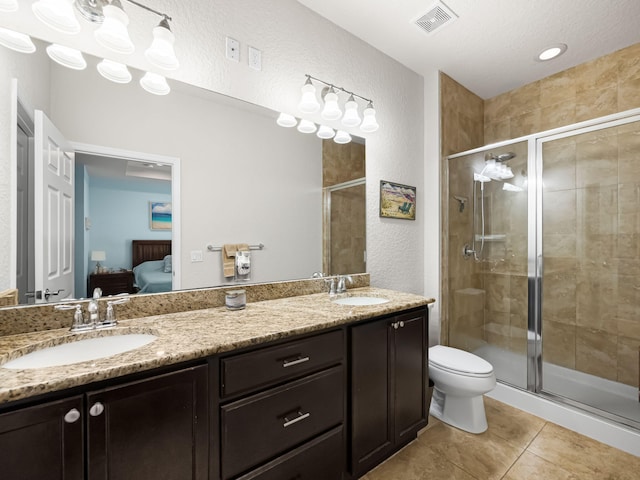 bathroom featuring vanity, an enclosed shower, tile patterned floors, and toilet