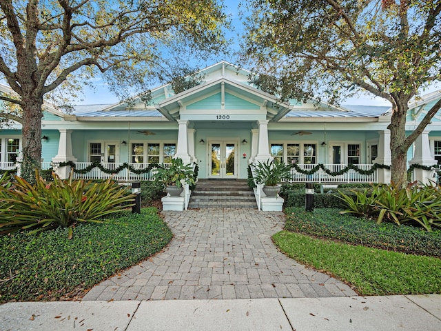 bungalow-style house featuring french doors and a porch