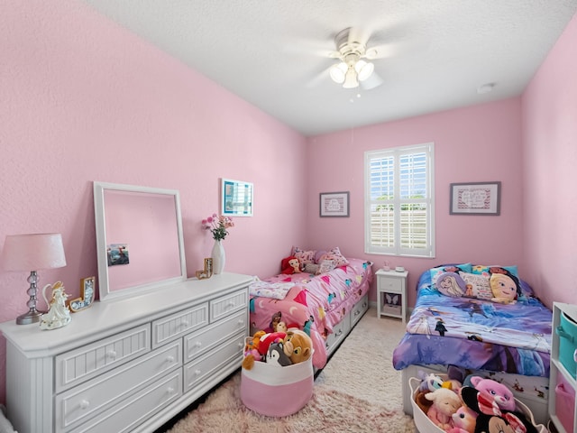 bedroom with light carpet and ceiling fan