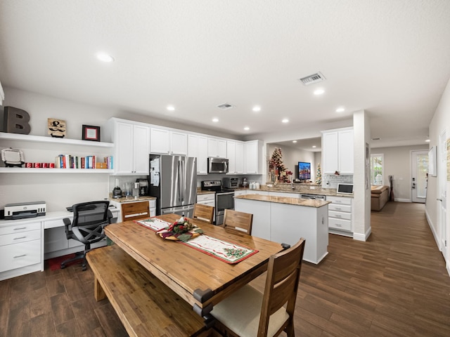 dining area with dark hardwood / wood-style flooring and built in desk