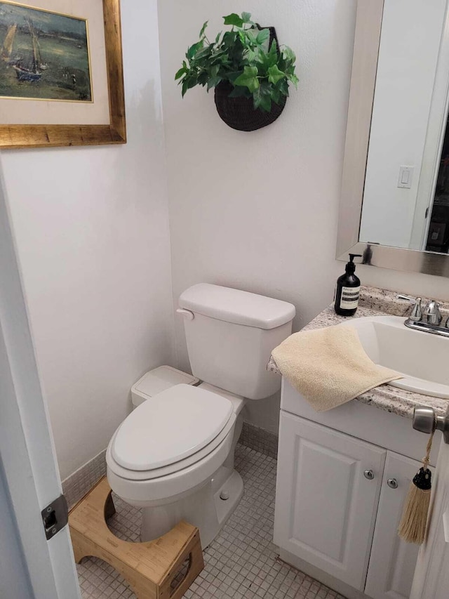 bathroom featuring tile patterned floors, vanity, and toilet