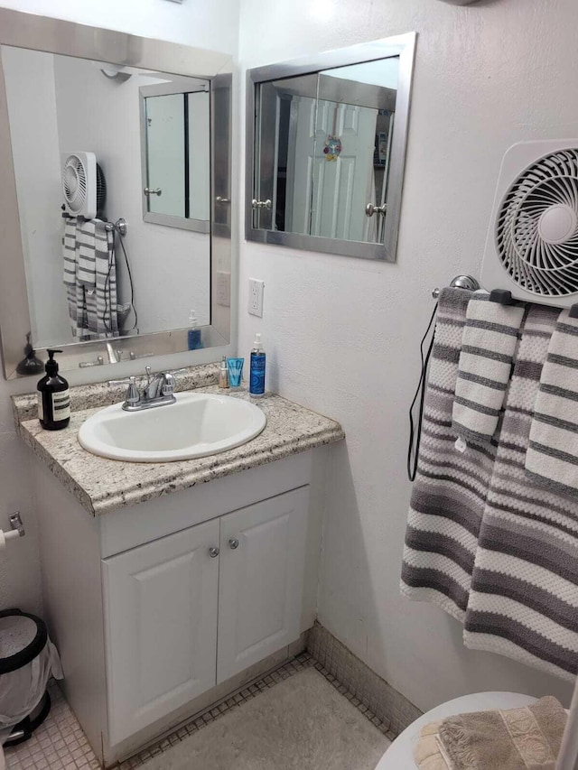 bathroom with tile patterned flooring and vanity