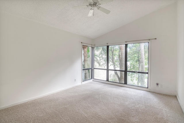 spare room with carpet flooring, ceiling fan, vaulted ceiling, and a textured ceiling