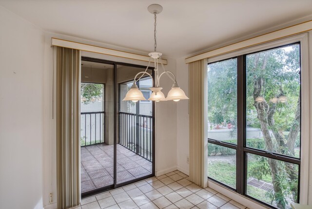 entryway with tile patterned floors and a chandelier