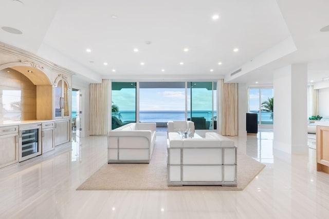 unfurnished living room with expansive windows, beverage cooler, and light tile patterned floors