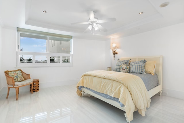 bedroom featuring a tray ceiling, ceiling fan, and ornamental molding