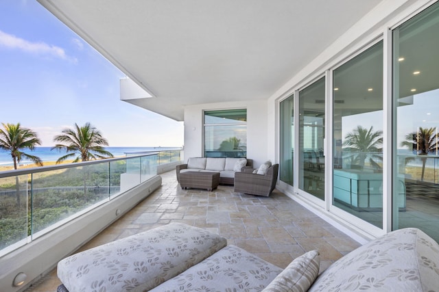 balcony with an outdoor hangout area and a water view