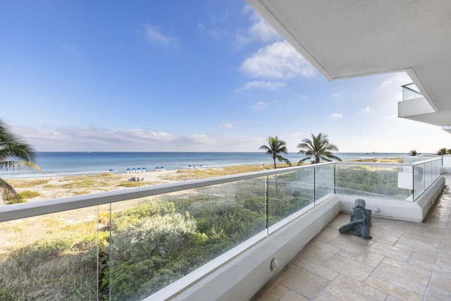 balcony with a beach view and a water view