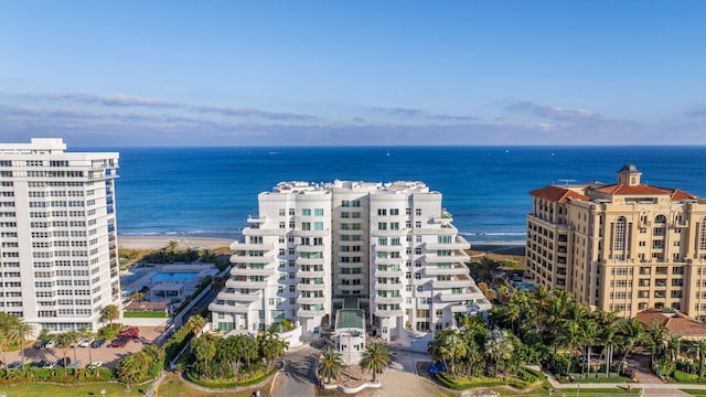 exterior space featuring a water view and a beach view