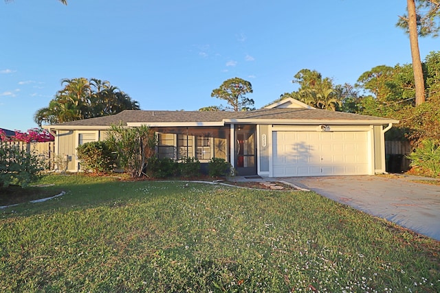 ranch-style home featuring a garage and a front lawn