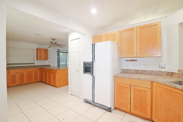 kitchen with kitchen peninsula, ceiling fan, white fridge with ice dispenser, and light tile patterned floors