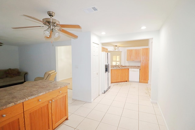 kitchen featuring ceiling fan, sink, light tile patterned floors, and white appliances