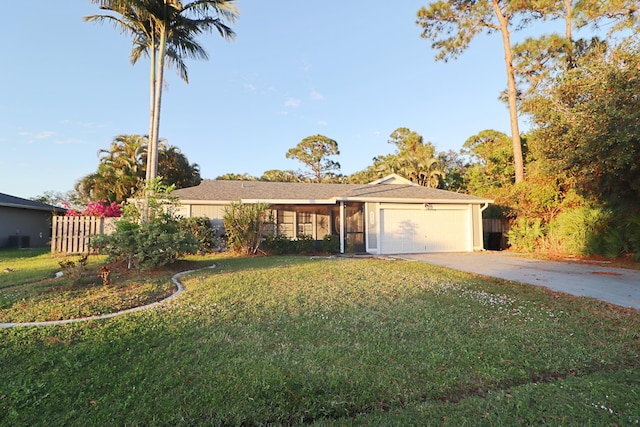 ranch-style house featuring a front yard and a garage