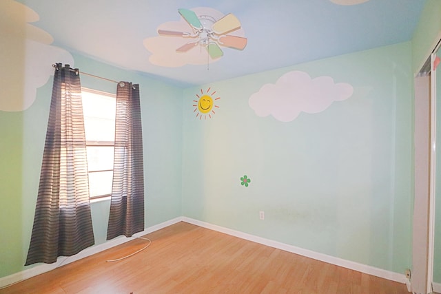 spare room with hardwood / wood-style flooring and ceiling fan