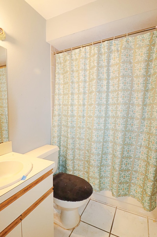 bathroom with tile patterned flooring, vanity, and toilet