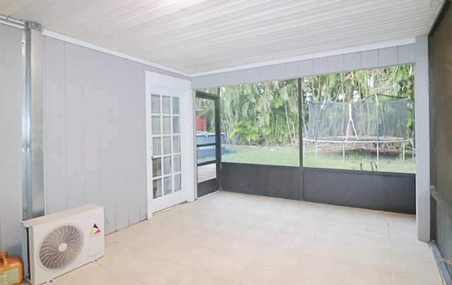 unfurnished sunroom with plenty of natural light and ac unit