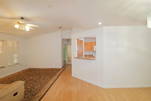 unfurnished room with light wood-type flooring and ceiling fan