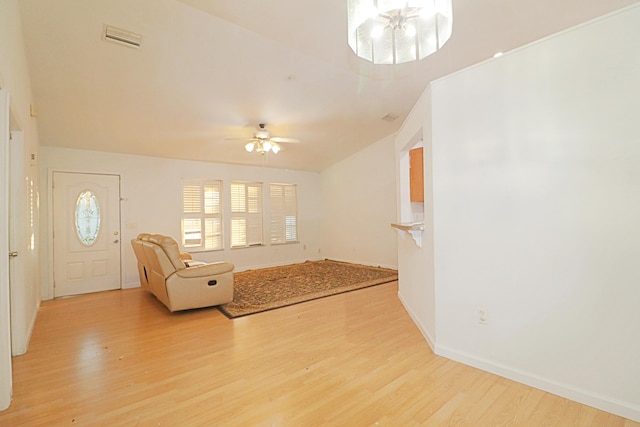 unfurnished living room with ceiling fan, light hardwood / wood-style flooring, and lofted ceiling