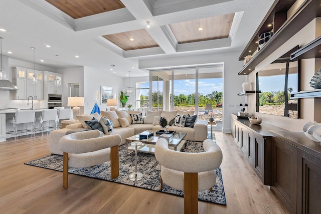 living room featuring recessed lighting, light wood-style flooring, coffered ceiling, and beamed ceiling