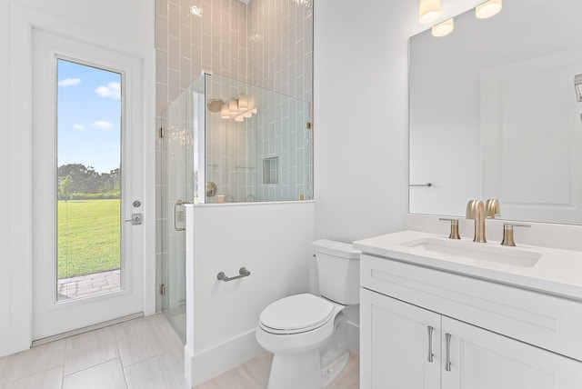 bathroom featuring vanity, toilet, an enclosed shower, and a healthy amount of sunlight