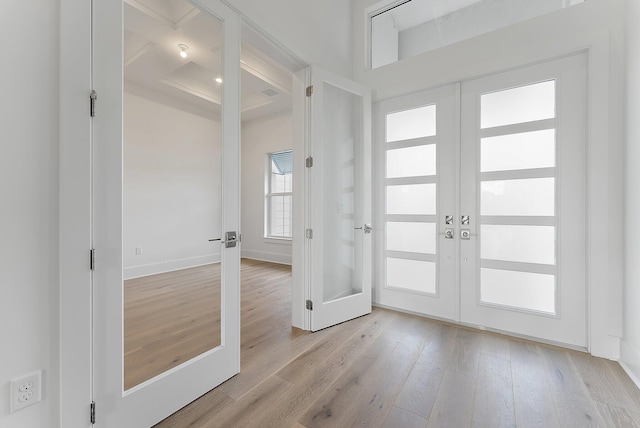 entryway with light hardwood / wood-style floors and french doors