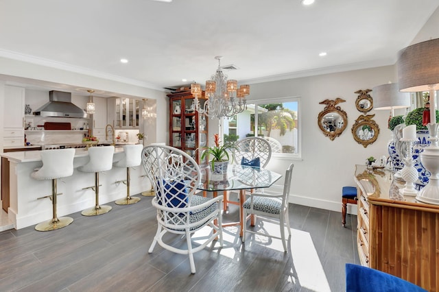 dining room with sink, a notable chandelier, dark hardwood / wood-style flooring, and crown molding