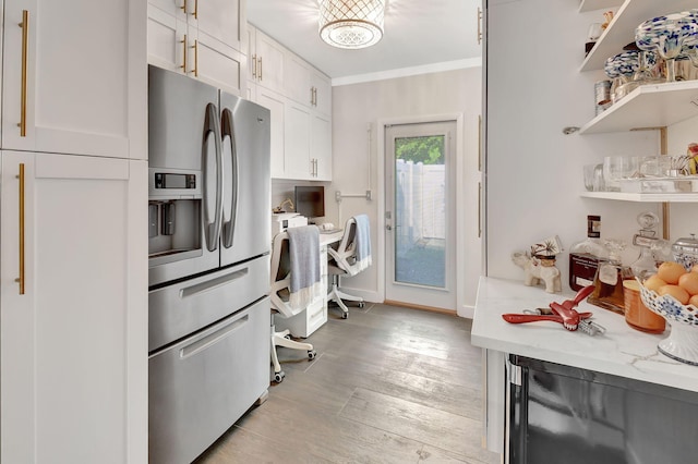 kitchen featuring light stone countertops, light hardwood / wood-style flooring, stainless steel refrigerator with ice dispenser, white cabinets, and ornamental molding