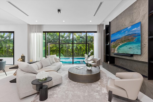 living room with light tile patterned floors and plenty of natural light