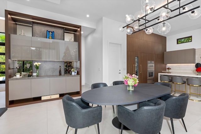 tiled dining space with a high ceiling