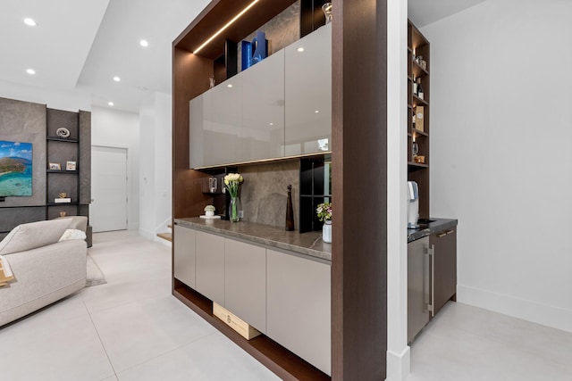 kitchen with light tile patterned flooring and white cabinetry