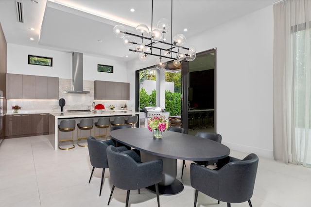 dining room featuring a notable chandelier and light tile patterned floors