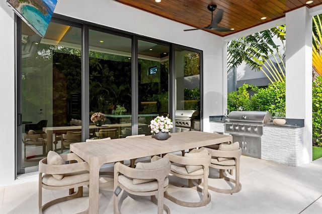 view of patio featuring ceiling fan, area for grilling, and grilling area