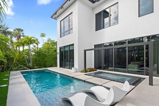 view of swimming pool with pool water feature, an in ground hot tub, and a patio area