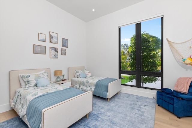 bedroom featuring multiple windows and light wood-type flooring