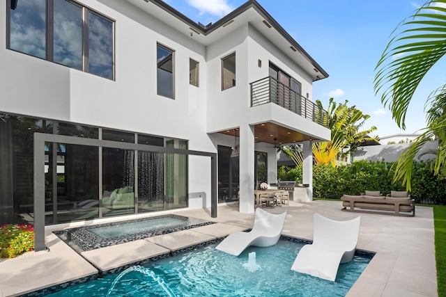 rear view of property featuring a patio, outdoor lounge area, a pool with hot tub, a balcony, and ceiling fan